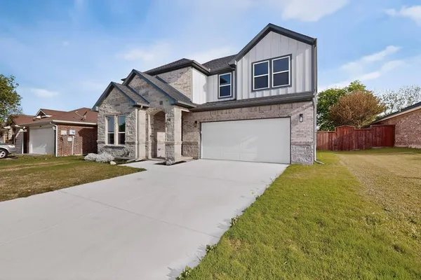 a front view of a house with a yard and garage