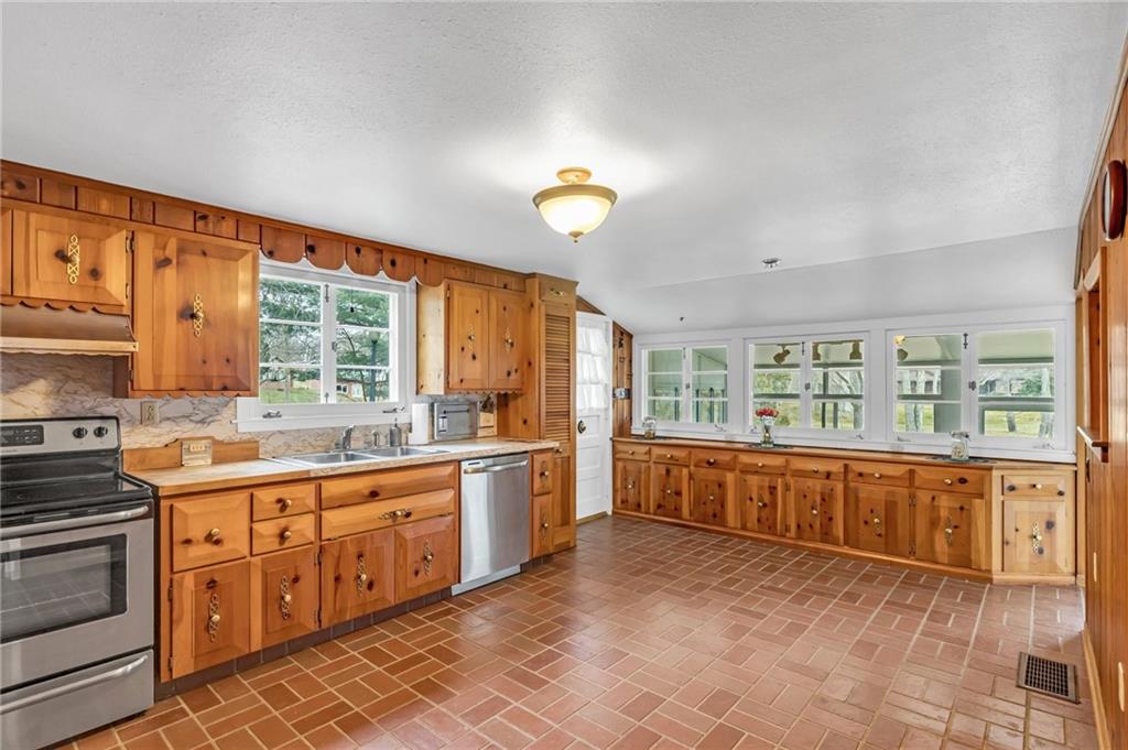 5802 Maple Way Jamestown, PA 16134 - Photo 7 of 24 a large kitchen with stainless steel appliances granite countertop a large window and a sink