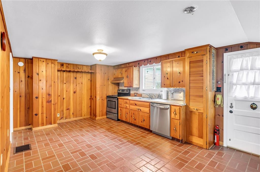 5802 Maple Way Jamestown, PA 16134 - Photo 8 of 24 a large kitchen with kitchen island granite countertop a refrigerator and cabinets