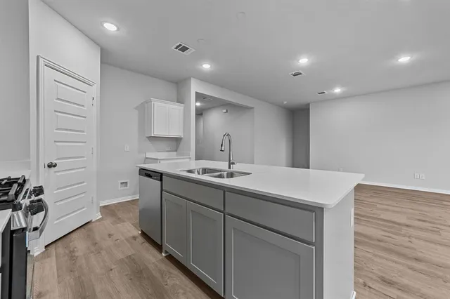 a kitchen with a sink stove and cabinets