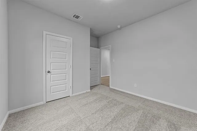 an empty room with closet area