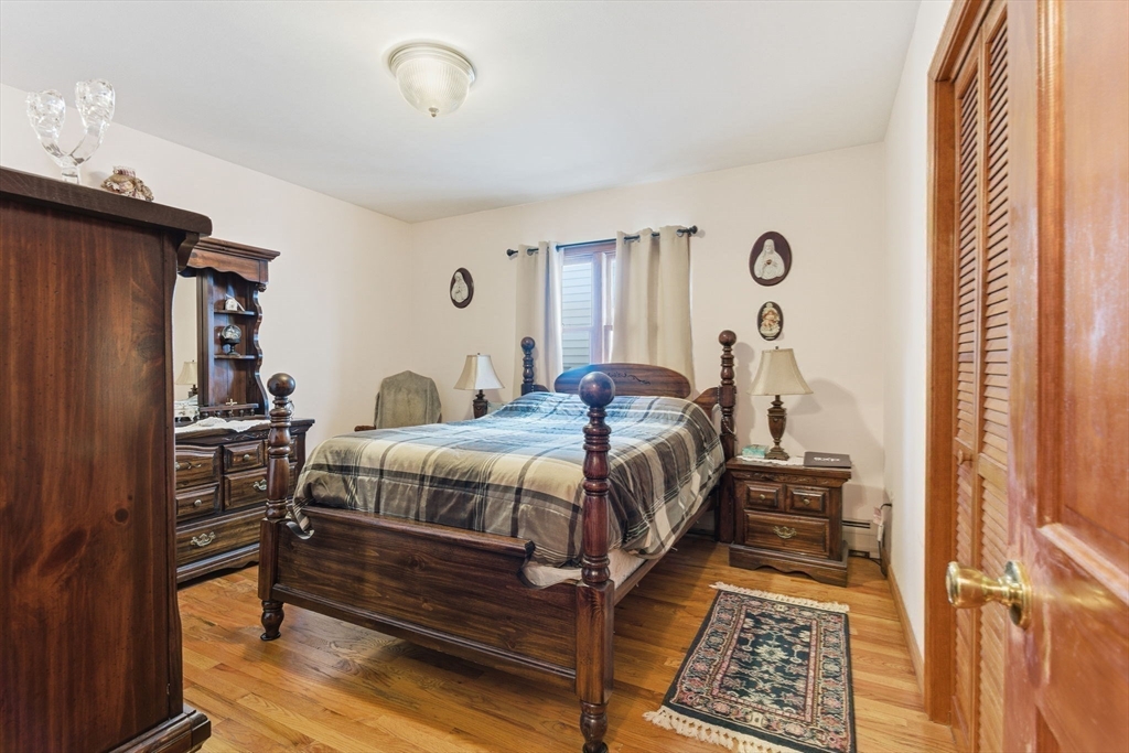 71-73 Oak Street Somerville, MA 02143 - Photo 11 of 42 a bedroom with a bed and a window