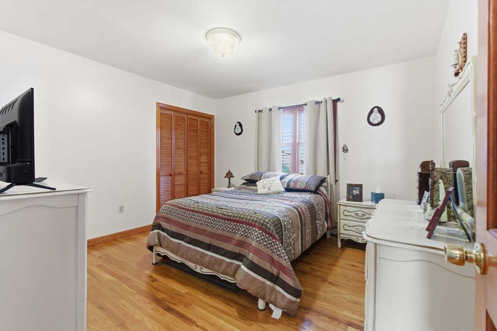 71-73 Oak Street Somerville, MA 02143 - Photo 13 of 42 a bedroom with a bed and flat screen tv