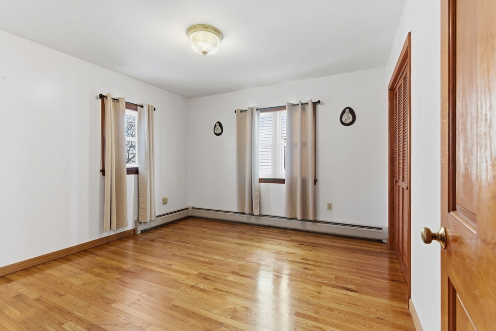 71-73 Oak Street Somerville, MA 02143 - Photo 14 of 42 an empty room with wooden floor and windows