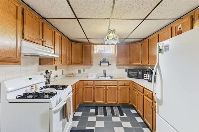 a kitchen with a sink a stove and cabinets