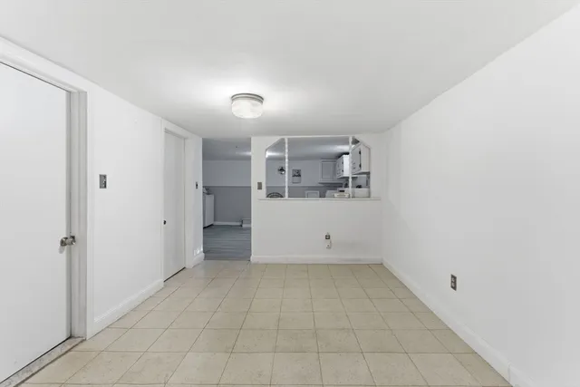 a view of a kitchen with a sink and a refrigerator