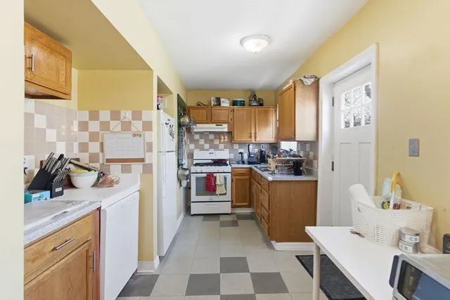 a kitchen with a sink appliances and cabinets