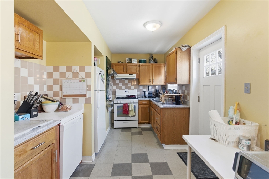 71-73 Oak Street Somerville, MA 02143 - Photo 25 of 42 a kitchen with a sink appliances and cabinets