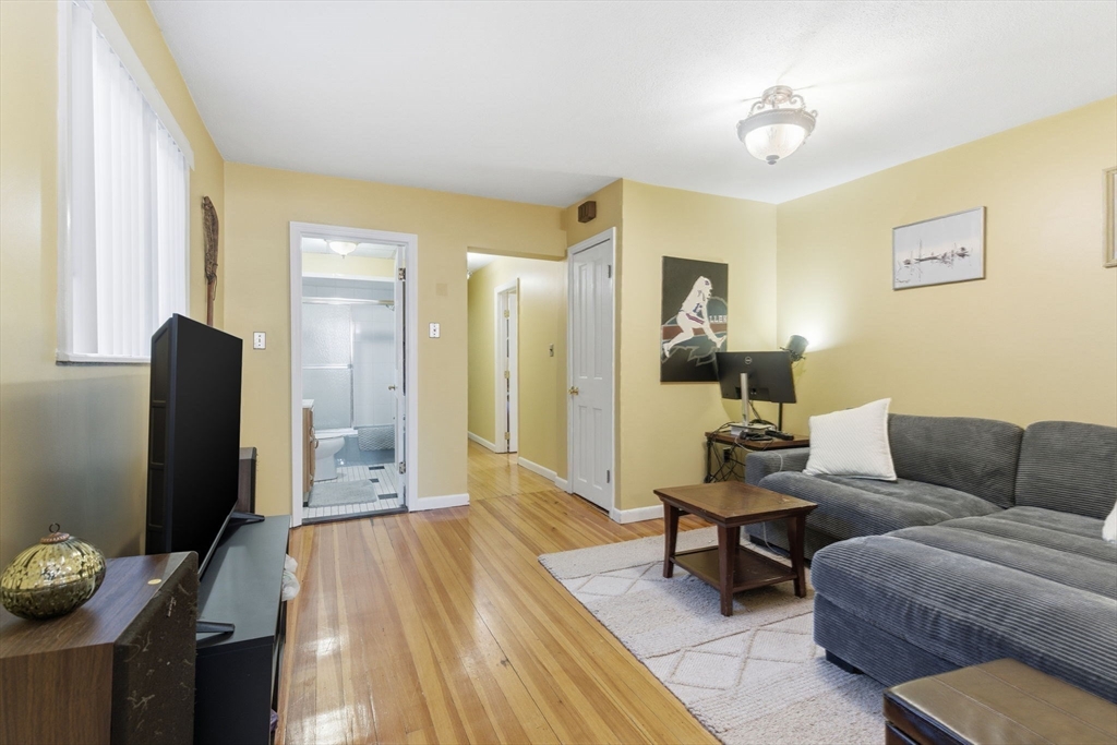 71-73 Oak Street Somerville, MA 02143 - Photo 26 of 42 a living room with furniture and a flat screen tv