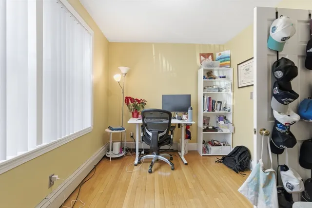 a view of a workspace with furniture and a window