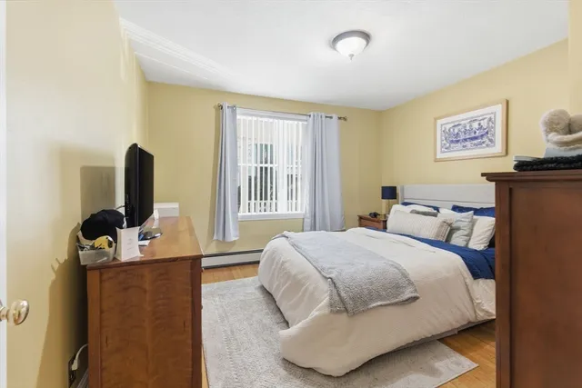 a bedroom with a bed and flat screen tv