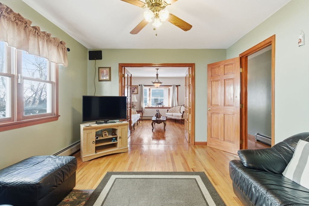 71-73 Oak Street Somerville, MA 02143 - Photo 6 of 42 a living room with furniture and a flat screen tv