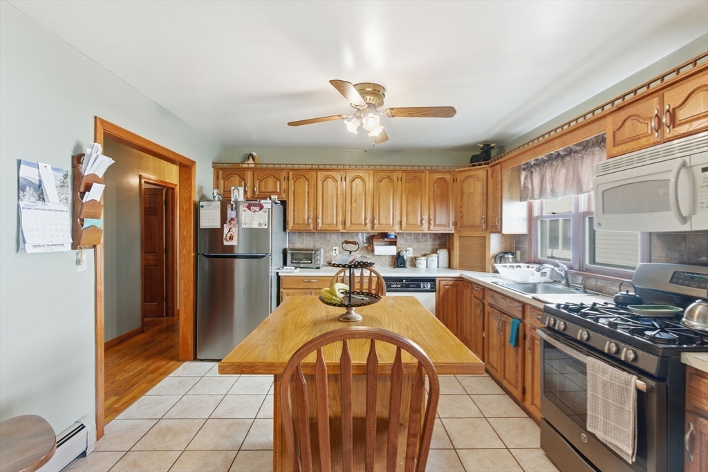 71-73 Oak Street Somerville, MA 02143 - Photo 8 of 42 a kitchen with stainless steel appliances granite countertop a stove refrigerator sink and cabinets