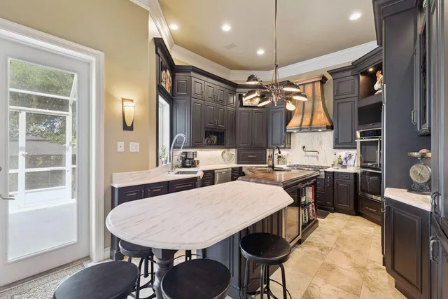 a kitchen with stainless steel appliances granite countertop a stove and a refrigerator