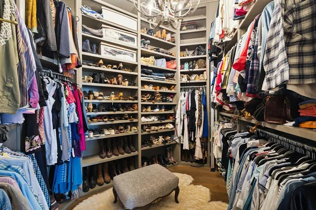 a living room with furniture a flat screen tv and a large window