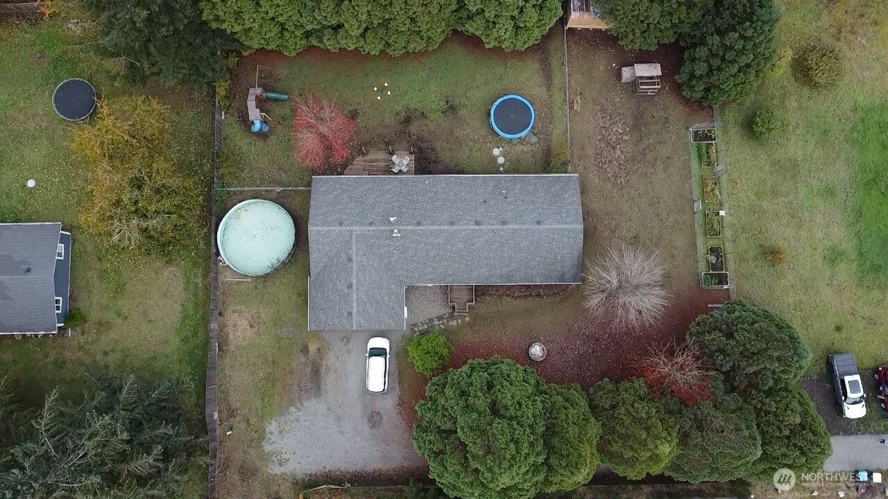an aerial view of a house with a yard
