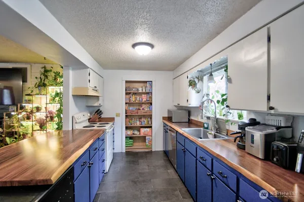 a kitchen with stainless steel appliances a sink stove and cabinets