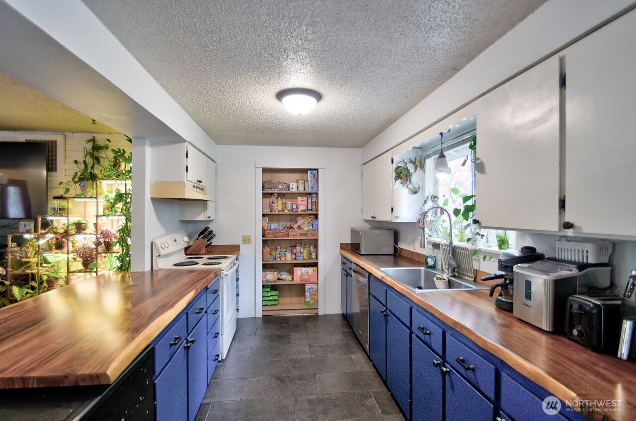 8548 178th Avenue Southwest Rochester, WA 98579 - Photo 11 of 30 a kitchen with stainless steel appliances a sink stove and cabinets