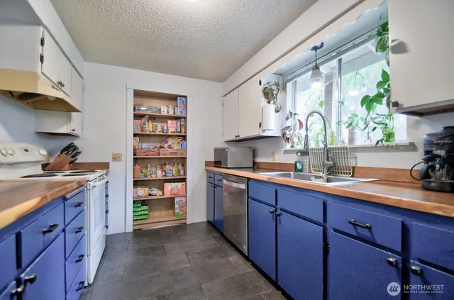 a kitchen with a sink window and cabinets