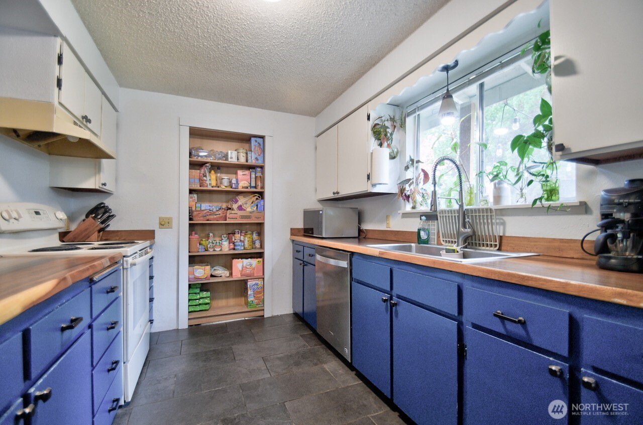 8548 178th Avenue Southwest Rochester, WA 98579 - Photo 12 of 30 a kitchen with a sink window and cabinets