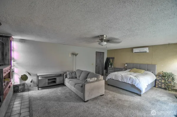 a spacious bedroom with a bed and a chandelier