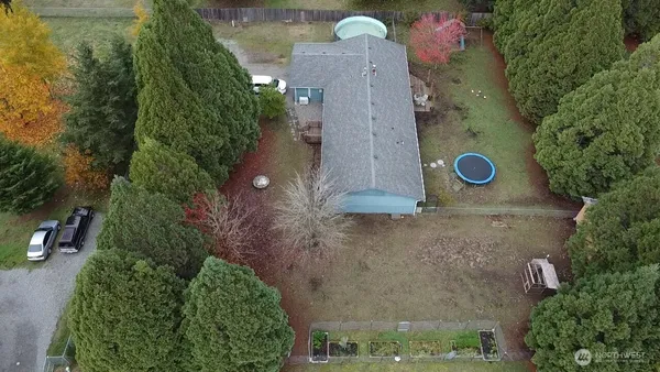 an aerial view of a house with a yard
