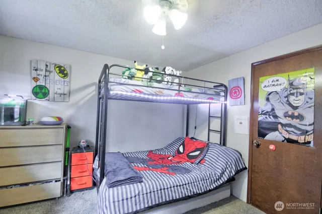 a bedroom with a bed and a chandelier