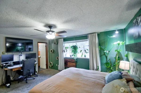 a bedroom with a bed and a chandelier