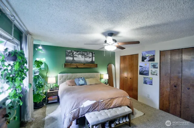 a bedroom with a bed and a chandelier