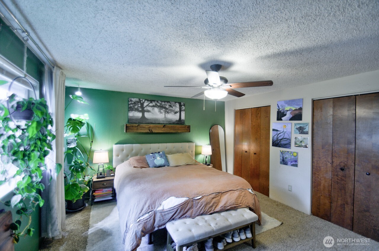 8548 178th Avenue Southwest Rochester, WA 98579 - Photo 26 of 30 a bedroom with a bed and a chandelier