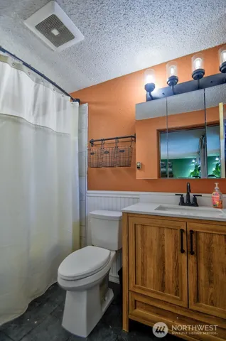 a bathroom with a toilet a sink and a mirror