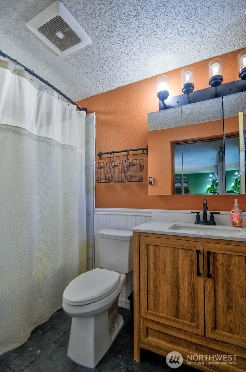 8548 178th Avenue Southwest Rochester, WA 98579 - Photo 28 of 30 a bathroom with a toilet a sink and a mirror