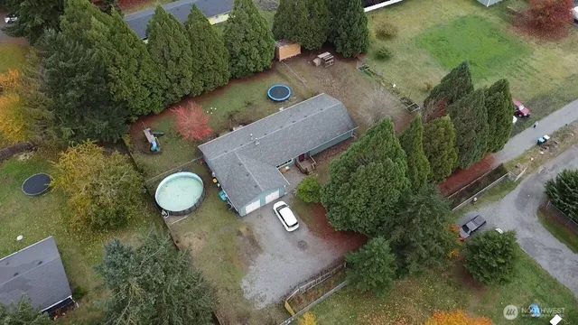 an aerial view of a house with yard