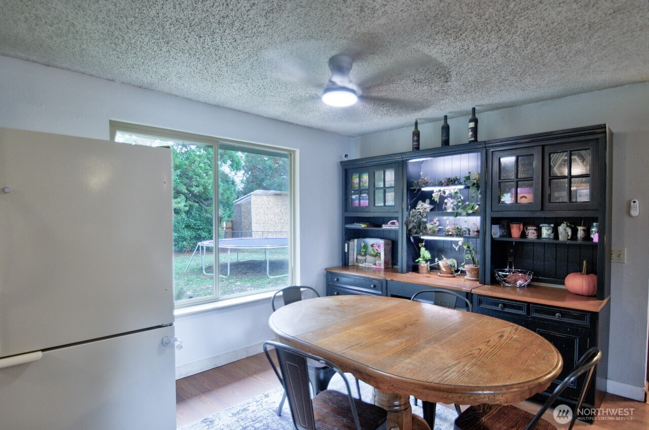 8548 178th Avenue Southwest Rochester, WA 98579 - Photo 8 of 30 a dining room with furniture a window and bookshelf