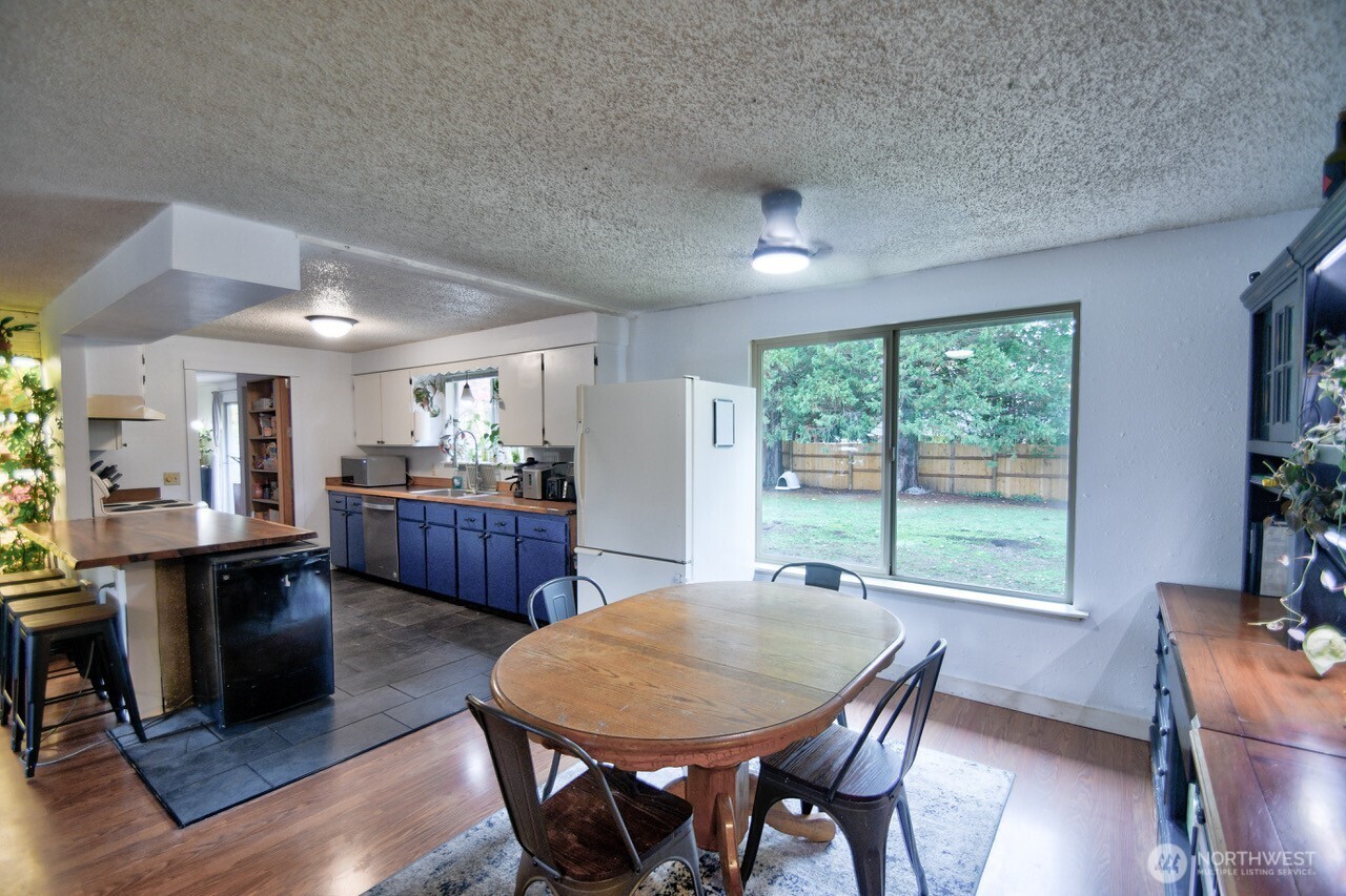 8548 178th Avenue Southwest Rochester, WA 98579 - Photo 9 of 30 a view of a dining room with furniture window and wooden floor