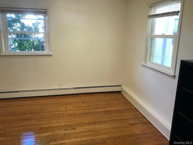 a view of a room with wooden floor and window