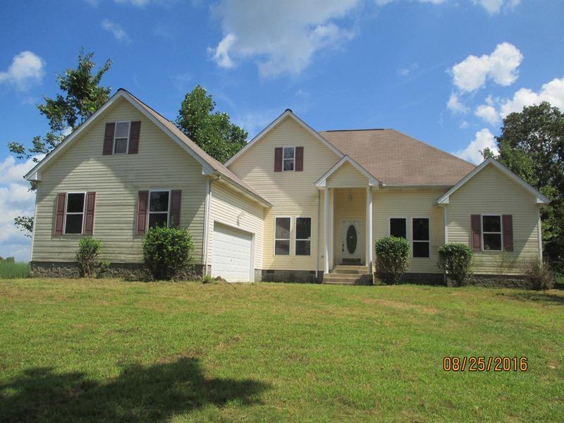 5101 Logan Road Cunningham, TN 37052 - Photo 1 of 8 a front view of a house with a yard