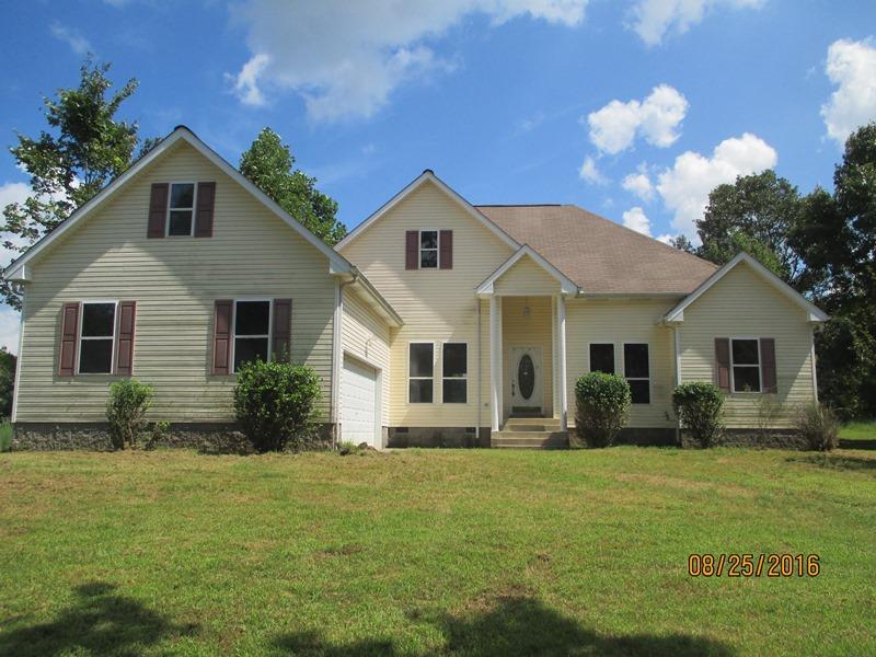 5101 Logan Road Cunningham, TN 37052 - Photo 2 of 8 a front view of a house with garden