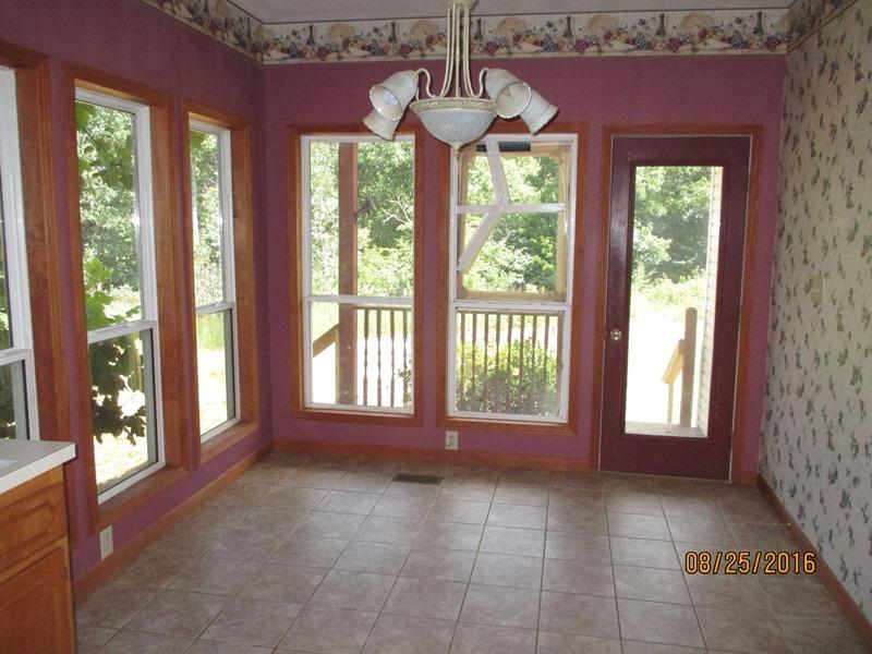 5101 Logan Road Cunningham, TN 37052 - Photo 6 of 8 a view of a room with large windows and wooden floor