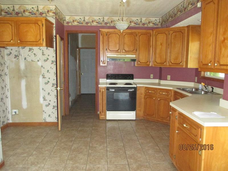 5101 Logan Road Cunningham, TN 37052 - Photo 7 of 8 a kitchen that has a sink and a stove