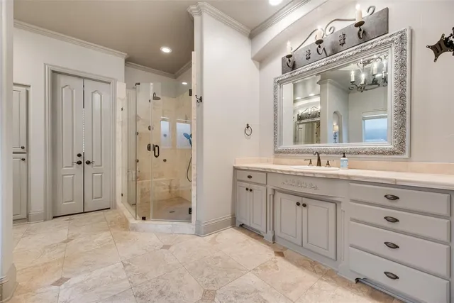 a bathroom with a granite countertop sink mirror and shower