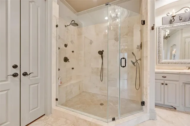 a bathroom with a glass shower door