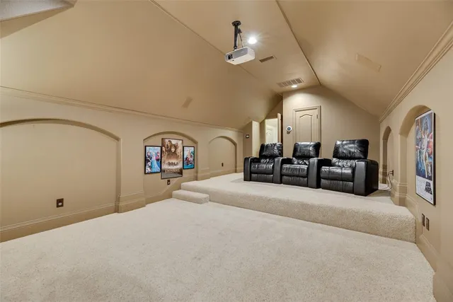 a large bed sitting in a room and a chandelier