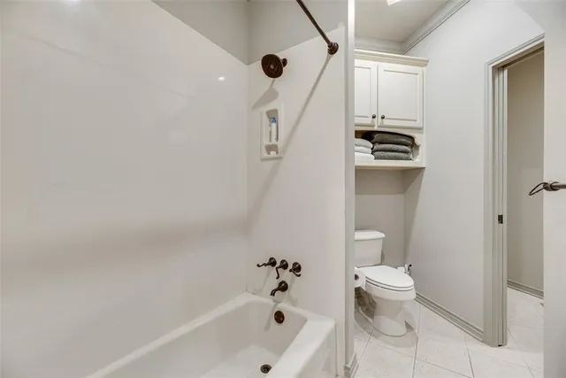 a bathroom with a bathtub a toilet and a shower