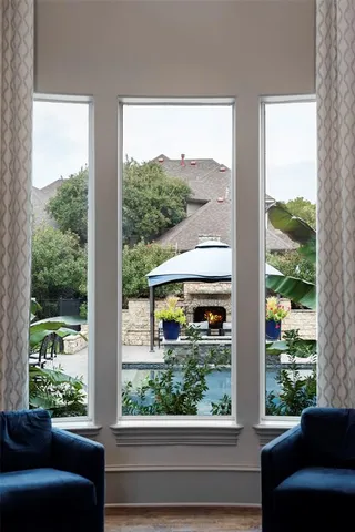 a view of a room with a large window and bed