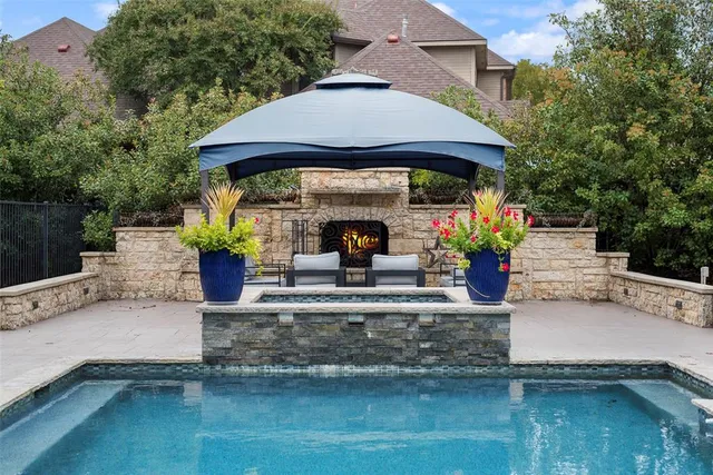 a view of house with swimming pool and sitting area