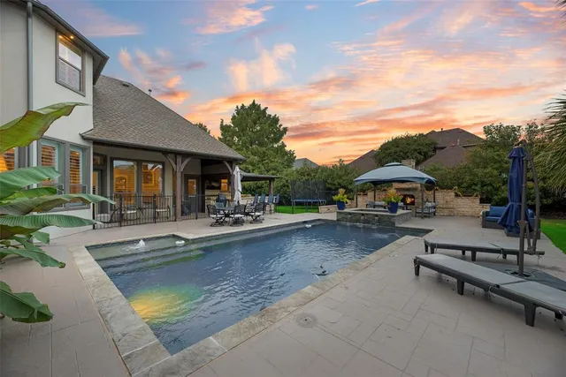 a view of a patio with swimming pool table and chairs