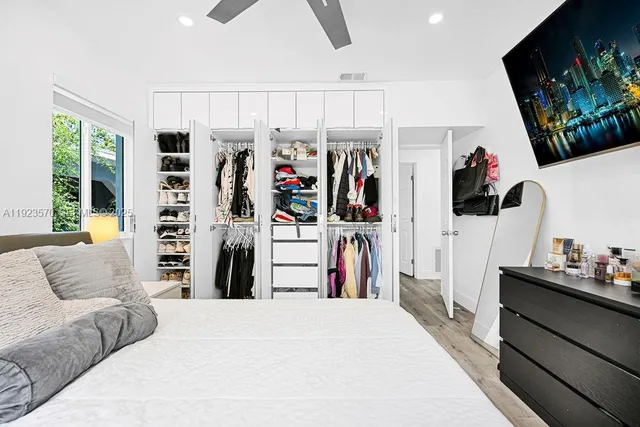 a view of a living room with closet and a flat screen tv