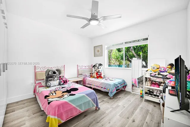 a bedroom with furniture and a wooden floor