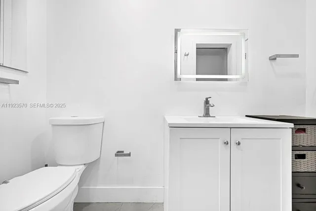 a bathroom with a toilet a sink and mirror